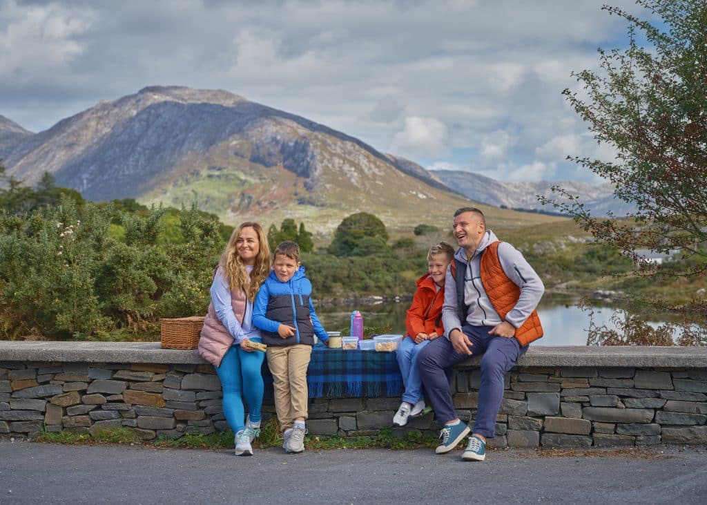 A family enjoying a picnic with a scenic mountain backdrop.