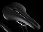 Close-up of the Trek Émonda ALR 5's black saddle with cut-out and textured surface.