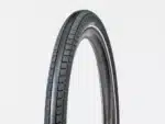 A black tyre Bontrager E6 Hard-Case Lite 27.5x2.40 Reflective tyre with textured tread upright.