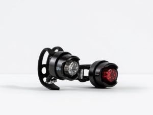 A pair of small bike lights, one with a white light and the other with a red light, are shown against a plain white background. They are affixed to black mounts, possibly for attachment to a bicycle. The brand name "Bontrager Glo/Ember Light Set" is visible on the light with the white light.