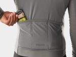 Person placing an energy bar into the back pocket of a Trek Circuit Thermal Cycling Jersey.