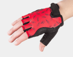 A hand wearing Trek Kids’ Unisex Bike Glove S/M in red and black with paper aeroplane pattern.