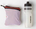 A white TREK water bottle beside a Bontrager Circuit Cycling Rain Jacket Extra Large.