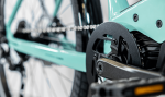 Close-up of an Allant+ 5 Lowstep Blue Sage bike’s chain, gear, and frame.