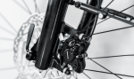 Close-up of an Allant+ 5 Lowstep Blue Sage bike disc brake and front spoke assembly, black & white.