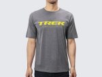 Man wearing a Trek T-shirt with a yellow "TREK" logo and white text below.